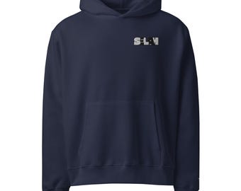 May include: Navy blue hooded sweatshirt with a front pocket and a drawstring hood. The word "SLAY" is printed in a stylized font on the upper chest. The sweatshirt is made of a soft material.