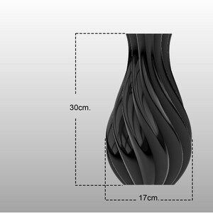 Puede incluir: Un jarr&oacute;n decorativo negro con un acabado brillante. El jarr&oacute;n tiene un dise&ntilde;o &uacute;nico y ondulado y mide aproximadamente 30 cm de alto y 17 cm de ancho. Es un elemento de decoraci&oacute;n del hogar moderno.