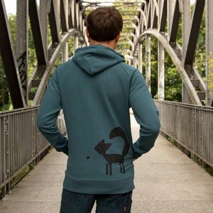 May include: A teal blue hooded sweatshirt with a black graphic of a cat on the back.