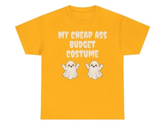 May include: A mustard yellow short-sleeve t-shirt featuring the white text MY CHEAP ASS BUDGET COSTUME printed in a bold, distressed font. Below the text are two small, smiling white ghost illustrations with raised arms and simple faces.