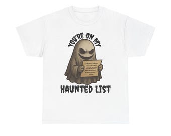 May include: A white short-sleeve t-shirt featuring a graphic of a tan ghost with a wide grin holding a tan paper. The text above the ghost reads YOU'RE ON MY and the text below the ghost reads HAUNTED LIST in a bold, dark, distressed font.