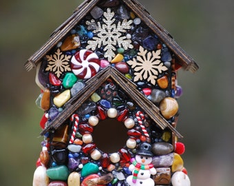 Christmas Birdhouse with Snowflakes, Christmas cheer and colorful Stones. Christmas decor and Centerpiece