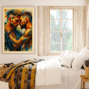 May include: An art print in a gold frame shows two men in an embrace, painted in blues, oranges, and yellows. The artwork hangs above a bed with white bedding, a plaid blanket, and a woven basket. A window with natural light is visible.