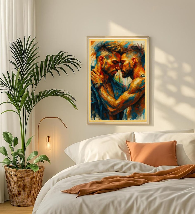 May include: A framed art print showing two men in an embrace, painted in vivid blues, oranges, and yellows. The artwork has a painterly style, with visible brushstrokes. The print is displayed in a bedroom setting, above a bed with white bedding.