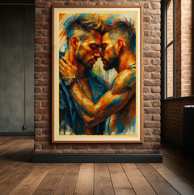 May include: A framed art print showing two men in an embrace, painted in vivid blues, oranges, and yellows. The artwork is mounted on a brick wall, with a wooden floor in the foreground. The painting has a contemporary, expressive style.