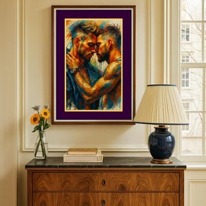 May include: A framed art print showing two men in an embrace, painted in vivid blues, oranges, and yellows. The artwork is a close-up of the figures, highlighting their bond. The frame is brown with a purple mount, adding a touch of elegance to the piece.