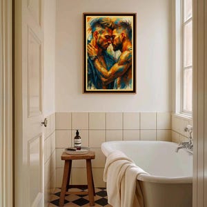May include: A framed artwork showing two men in an embrace, painted with vivid blues, oranges, and yellows. The print is displayed above a wooden stool in a bathroom, with a white bathtub and a black and white tiled floor.