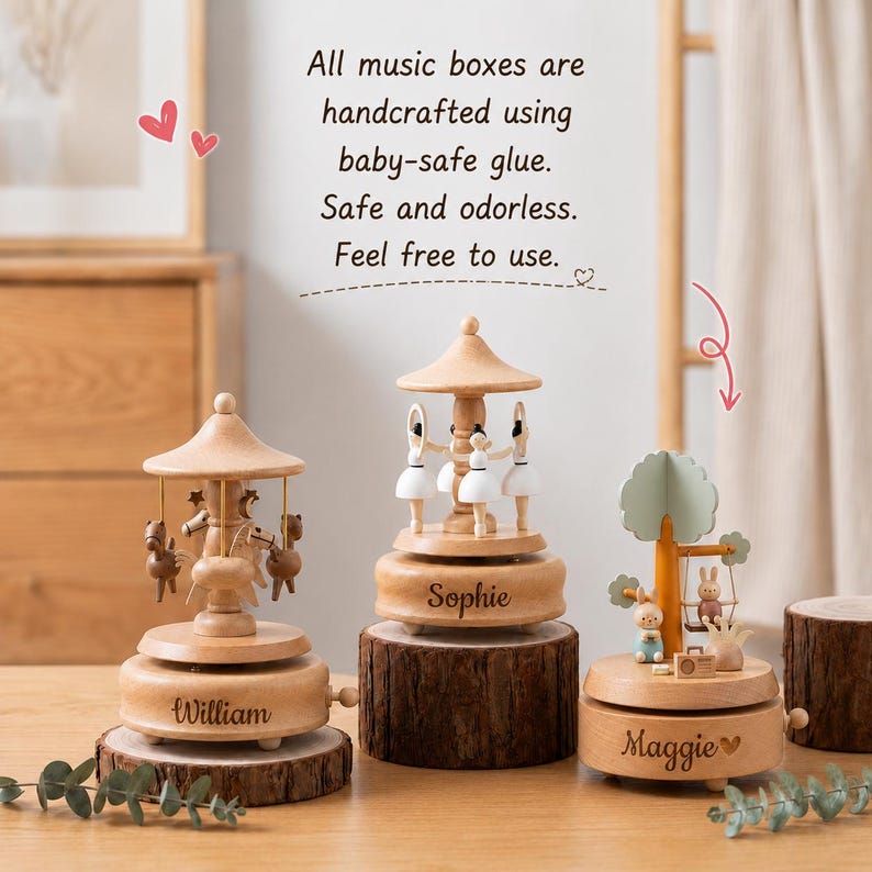 May include: Three wooden music boxes with natural finishes. The left features horses, the center features ballerinas, and the right features rabbits on a swing. Each base is engraved with names: William, Sophie, and Maggie. Text reads: All music boxes are handcrafted using baby-safe glue. Safe and odorless. Feel free to use.