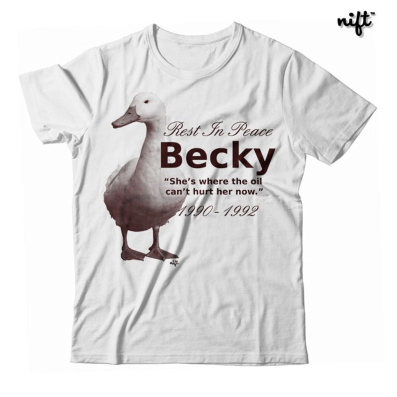 May include: White t-shirt with a brown duck illustration and the text "Rest In Peace Becky" "She's where the oil can't hurt her now." 1990-1992.
