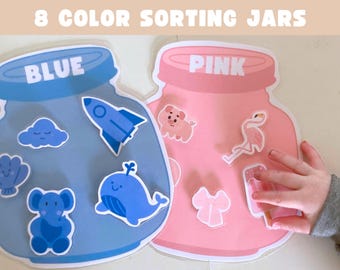 Puede incluir: Dos alfombrillas de clasificación con forma de tarro etiquetadas 8 COLOR SORTING JARS. El tarro azul presenta una nube, un cohete, una concha, un elefante y una ballena. El tarro rosa presenta un cerdo, un flamenco, un lazo y un helado.