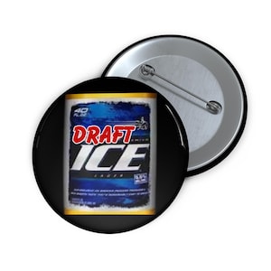 May include: A black button featuring a design from a "Draft Ice" beer can. The design includes the words "DRAFT" in red and "ICE" in white, set against a blue background. A second button is visible in the background.