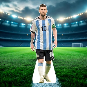 May include: A person wearing a light blue and white striped soccer jersey with the number 10 on the front and back, black shorts, and white socks. The person is standing on a white path on a green field.