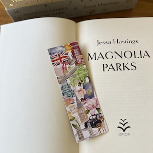 May include: A colourful bookmark with London-themed illustrations, including a red telephone box, Union Jack, and Big Ben, placed in a book titled "Magnolia Parks" by Jessa Hastings. The book is open.