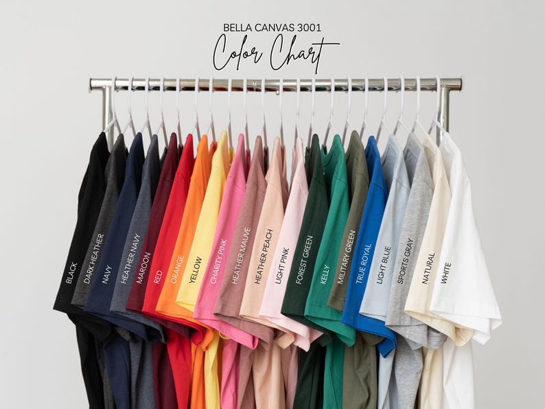 A row of colorful t-shirts hanging on a clothing rack, with each shirt displaying a different color.
