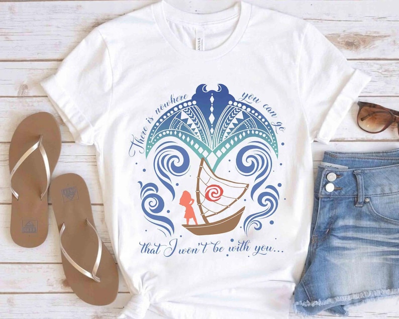 May include: White t-shirt with a colourful graphic design featuring a boat, waves, and the text "There is nowhere you can go that I won't be with you...". The shirt is paired with denim shorts and brown sandals.