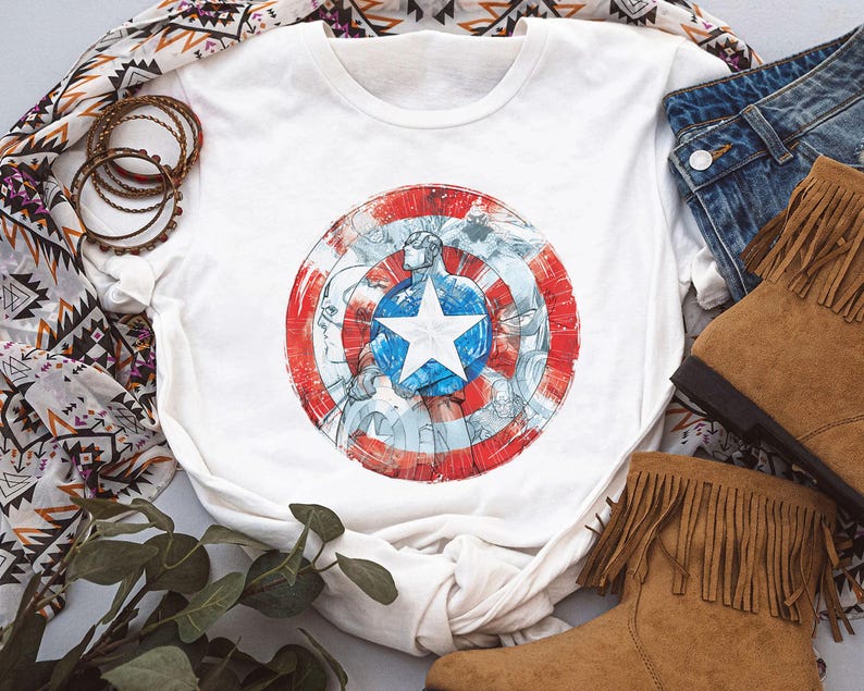 May include: A white ceramic mug with a black handle and the text "But First, Coffee" in a bold, black font. The mug is set against a blurred background, highlighting its clean design.