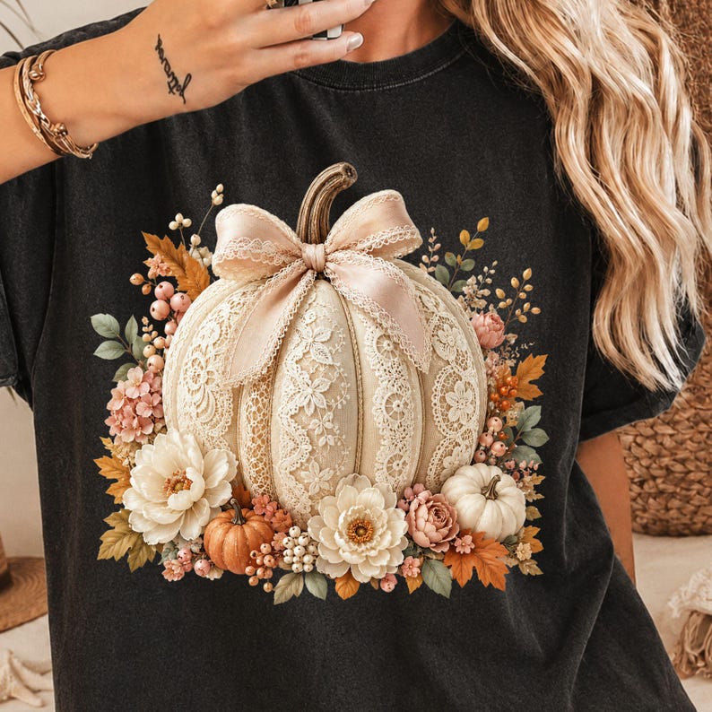 500-character alt text:
Lace pumpkin shirt PNG displayed on a warm autumn shirt mockup with a soft boutique fall look. The design includes a cream pumpkin covered in lace border details, floral lace panels, a blush bow, ivory flowers, pink blossoms, fall leaves, berries, greenery, and small pumpkins. Ideal for pumpkin patch shirts, fall pumpkin shirt designs, coquette fall PNG, preppy fall PNG, lace border PNG, pumpkin bow PNG, floral pumpkin PNG, and trendy autumn apparel mockups.