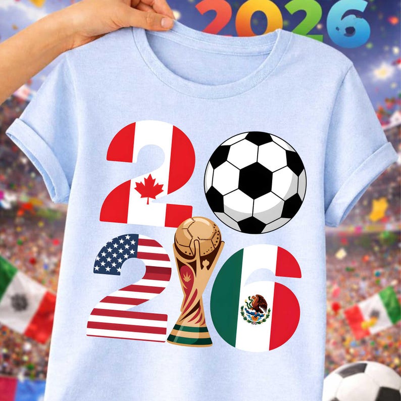 Road to 2026 soccer PNG design shown on a light blue t-shirt mockup with a stadium crowd background, highlighting the year 2026 with United States, Canada, and Mexico flag elements, a classic soccer ball, and a golden trophy graphic. This transparent high-resolution PNG is perfect for print on demand shirts, youth soccer apparel, fan gear, sublimation printing, and football-themed designs for the 2026 global soccer tournament.