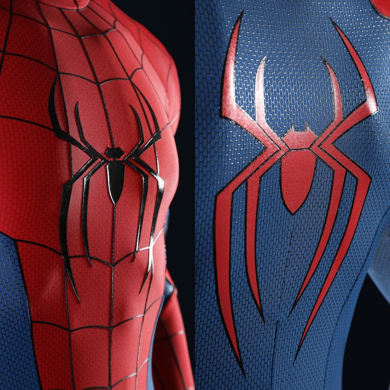 May include: A red and blue textured bodysuit featuring a black spider emblem on the chest and a large red spider emblem on the back. The red fabric has a black web pattern, while the blue fabric has a distinct honeycomb-like surface texture.