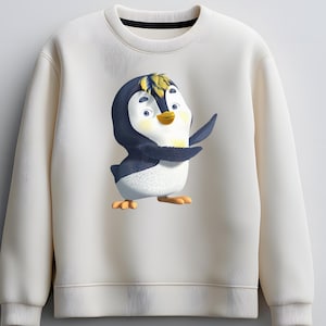 K&ouml;nnte beinhalten: Cremefarbenes Sweatshirt mit einem Cartoon-Pinguin-Design. Der Pinguin hat einen blau-schwarzen K&ouml;rper, gelbes Haar und orangefarbene F&uuml;&szlig;e. Das Sweatshirt hat einen Rundhalsausschnitt und lange &Auml;rmel. Der Pinguin l&auml;chelt und hat den Arm erhoben.
