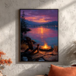 May include: A framed landscape painting depicts a serene lake scene at sunset. A wooden chair sits near a campfire on the shore. The painting's colors include shades of purple, orange, and blue, creating a warm and inviting atmosphere. The scene evokes a sense of tranquility and relaxation.