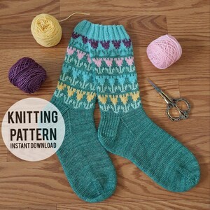 May include: Knitting pattern for teal socks with a colorful heart and flower design. The pattern includes instructions for knitting the socks with a variety of colors, including teal, pink, yellow, and purple.