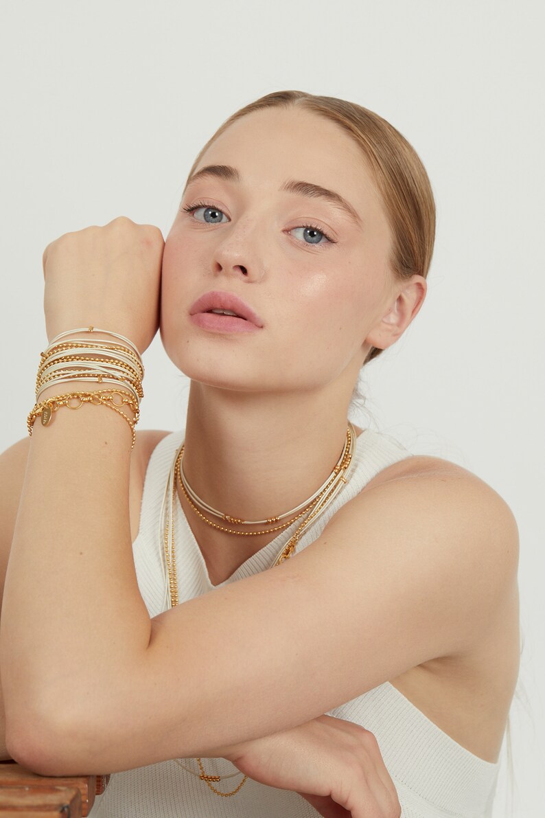 May include: A set of gold beaded bracelets and necklaces.