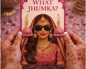 May include: A pink and gold illustration of a woman wearing sunglasses and traditional Indian jewelry, holding a sign that reads "WHAT JHUMKA?". The woman is wearing a pink and gold outfit. The image is held by hands with henna tattoos.