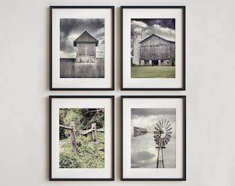May include: Four framed black and white photographs of rural scenes. The images include a barn, a windmill, a fence, and a building with a cupola. The photographs are displayed on a white wall.