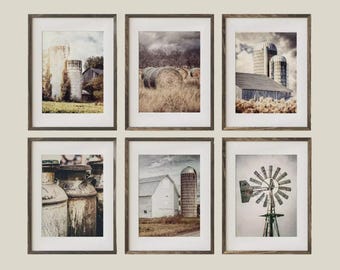 May include: Set of six framed prints featuring rural farm scenes. The images depict barns, silos, hay bales, and a windmill in a rustic, vintage style. The color palette includes muted tones of brown, beige, and gray, evoking a sense of nostalgia and country living.