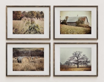 May include: Four framed landscape prints with rustic brown frames. The prints depict rural scenes: a field of crops, a barn, hay bales, and a bare tree. The prints have a vintage, sepia-toned aesthetic.