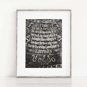 May include: Black and white framed art print with the quote "Time Is Eternity" and the name "Yaddo" and the year "1901". The artwork features ornate, vintage-style lettering and decorative flourishes. The frame is a light wood color.