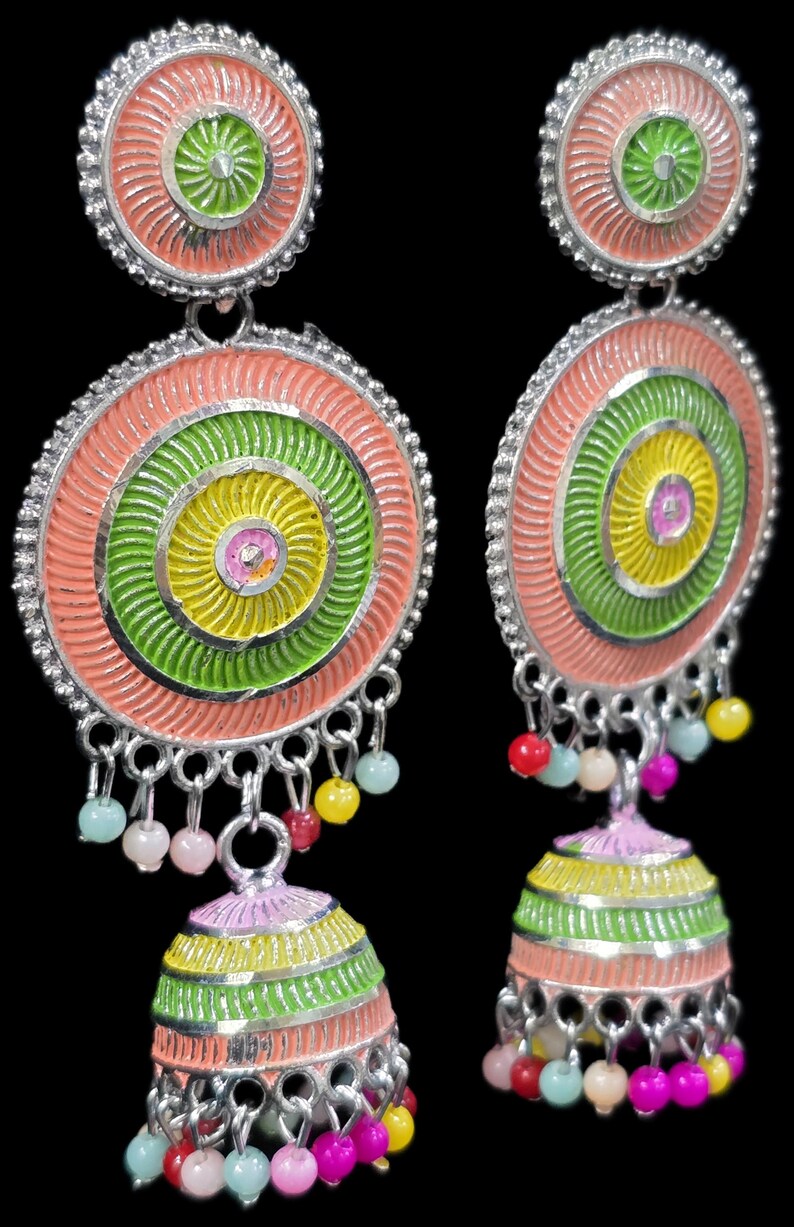 K&ouml;nnte beinhalten: Bunte, handgefertigte Ohrringe mit kreisf&ouml;rmigem Design. Die Ohrringe zeigen konzentrische Kreise in Rosa, Gr&uuml;n und Gelb, mit kleinen, h&auml;ngenden Perlen in verschiedenen Farben. Die Ohrringe haben eine silberfarbene Metalloberfl&auml;che und eine glockenf&ouml;rmige Basis.