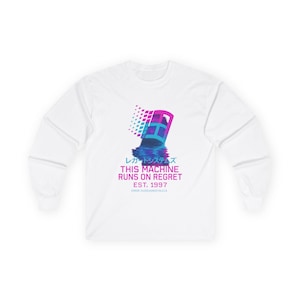 May include: White long-sleeve shirt featuring a vaporwave design. The graphic includes a pixelated window with Japanese text and the phrase "THIS MACHINE RUNS ON REGRET EST. 1997" in a retro font. The design uses shades of blue, pink, and purple.
