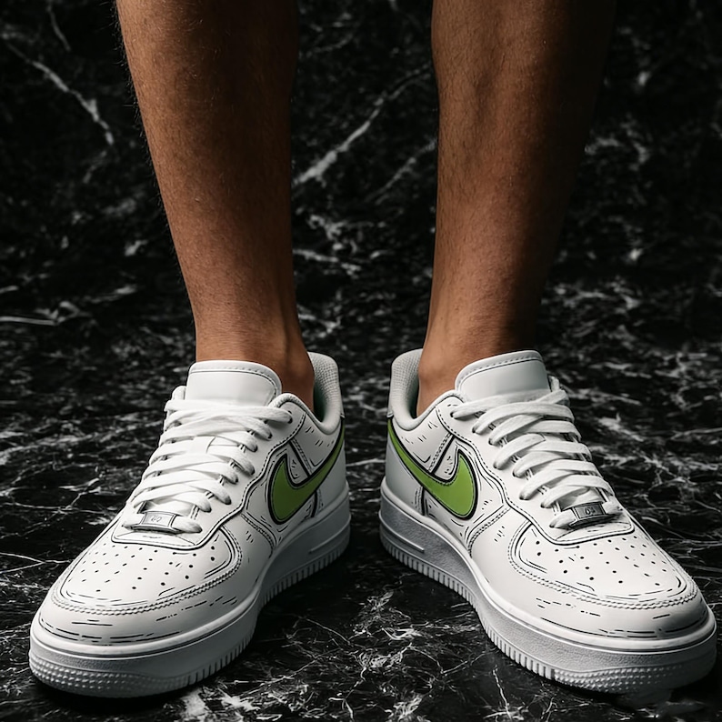May include: White sneakers with a cartoon-style outline and a green Nike swoosh. The shoes have white laces and a thick white sole. The sneakers are on a black and gray marble surface.