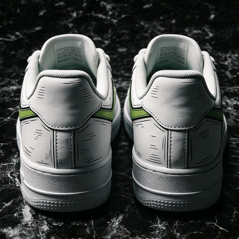 May include: Pair of white sneakers with black outline detailing and a green accent stripe. The shoes have a classic design with a thick white sole and are set against a dark, textured background.