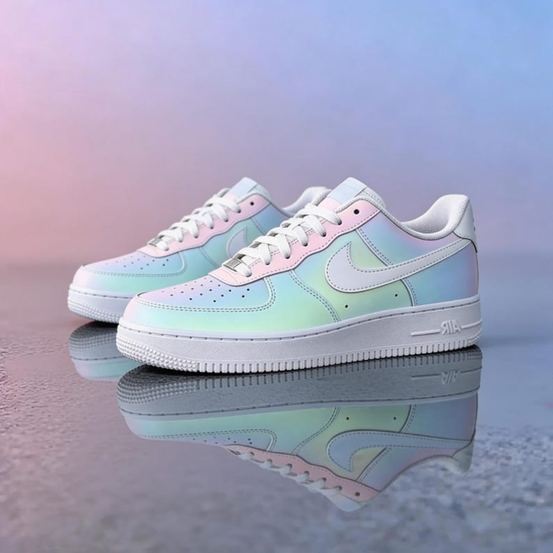 May include: A pair of iridescent sneakers with a pearlescent finish. The shoes have a white sole, laces, and Nike swoosh. The color gradient transitions from light blue to pink and green. The shoes are reflected in the shiny surface.
