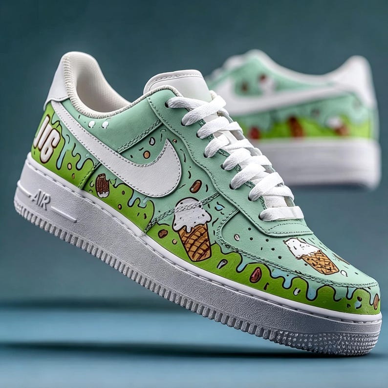 May include: Mint green and white sneakers with custom ice cream cone designs. The shoes feature white laces, a white Nike swoosh, and the word "AIR" on the midsole. The design includes dripping green accents and brown details.