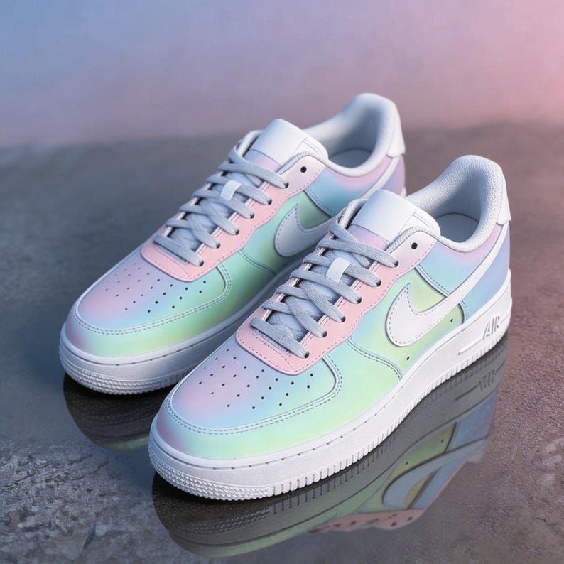 May include: A pair of pastel-colored sneakers with a gradient design of pink, blue, and green hues. The shoes have white soles, laces, and a Nike swoosh. The sneakers are displayed on a reflective surface.