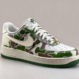 May include: White, green, and brown camouflage Air Force 1 sneakers. The shoe features a white swoosh, laces, and midsole. The outsole and trim are green. The tongue has a green logo. The toe box has small perforations.