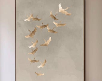 May include: A large framed artwork featuring a flock of stylized birds in flight against a muted gray background. The birds are rendered in shades of gold and brown. The artwork hangs above a modern chair and a black coffee table.
