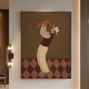 May include: A framed wall art print featuring a painting of a person wearing a white hat, a dark purple vest over a light pink long-sleeved shirt, and cream-colored striped trousers, holding a small brown dog against a brown and diamond-patterned floor.