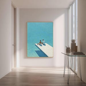 May include: A framed painting depicts two figures seated on a white dock over turquoise water. The artwork has a minimalist style with a bright, sunny aesthetic. The painting is displayed in a well-lit room with a glass table and a window.
