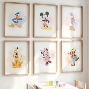 May include: Six framed watercolour prints featuring Disney characters: Donald Duck, Mickey Mouse, Daisy Duck, Pluto, Minnie Mouse, and Goofy. Each print has a light background with a watercolour wash and a wooden frame. The characters are in their classic poses.