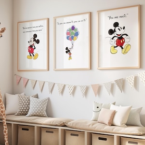 May include: A children's room scene featuring three framed Mickey Mouse art prints with inspirational quotes. A giraffe plush toy stands near a window. A bench with storage cubes, pillows, and a pennant banner complete the decor.