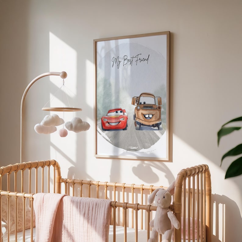 May include: A framed print featuring two cartoon cars, one red and one brown, on a gray road. The text "My Best Friend" is written above the cars. The print is displayed in a nursery setting with a wooden crib and mobile.