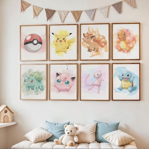 May include: A collection of eight framed watercolor prints featuring various Pok&eacute;mon characters. The prints include Pikachu, Charmander, Squirtle, Bulbasaur, Jigglypuff, Vulpix, Mew, and a Pok&eacute; Ball. The artwork is displayed above a daybed with pillows.