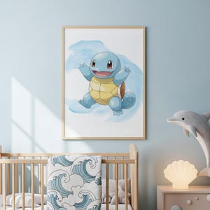 May include: A framed watercolor print of a blue Squirtle character with a yellow shell, set against a blue watercolor wash. The artwork is displayed in a light wood frame, suitable for a nursery or children's room.