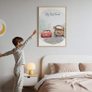 May include: A framed print featuring watercolor illustrations of two cartoon cars, a red race car and a brown tow truck, on a gray road. The text "My Best Friend" is written above the cars. The print is in a light wood frame.