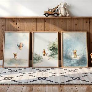 May include: Three framed watercolor prints featuring Winnie the Pooh. One shows Pooh with balloons, another walking with Piglet, and the last with a wand. A wooden shelf holds a toy truck, teddy bear, and stuffed bear.